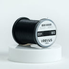 Spool of black Veevus Thread Polyester 8/0 with 'Veevus' label on a white background