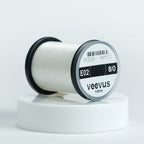 Spool of white  Veevus Thread Polyester 8/0with 'veevus' branding on a white background