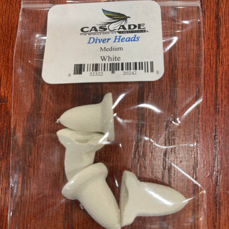 Packaged diver heads with a Cascade label on a wooden surface