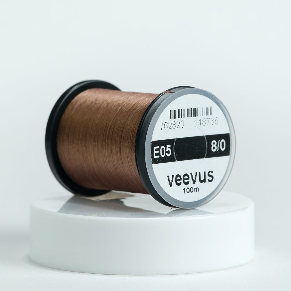 Spool of brown Veevus Thread Polyester 8/0 with 'veevus' label on a white background