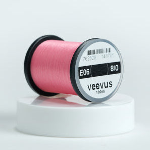 Spool of pink Veevus Thread Polyester 8/0 with 'veevus' branding on a white background