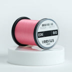 Spool of pink Veevus Thread Polyester 8/0 with 'veevus' branding on a white background