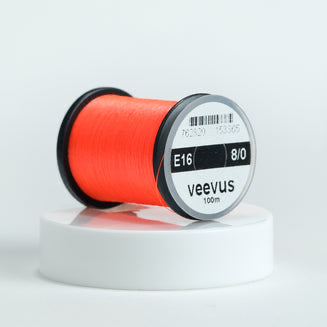 Spool of red Veevus Thread Polyester 8/0 with 'veevus' branding on a white background