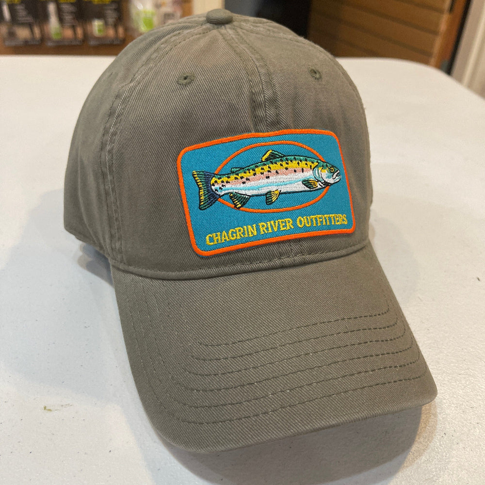 Green cap with a fish logo on a white surface