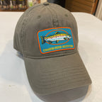 Green cap with a fish logo on a white surface