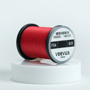Spool of red Veevus Thread Polyester 6/0 with a 'veevus' label on a white background