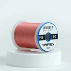Spool of pink Veevus Thread Polyester 6/0 with 'veevus' branding on a white background