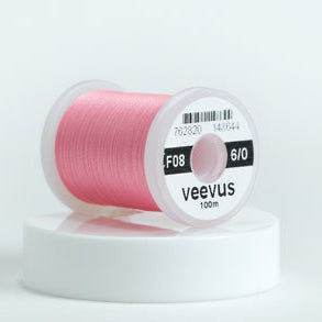 Spool of pink Veevus Thread Polyester 6/0 with 'veevus' branding on a white background