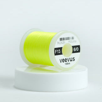 Spool of yellow Veevus Thread Polyester 6/0 with 'veevus' branding on a white background