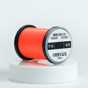 Spool of red Veevus Thread Polyester 6/0 with 'veevus' branding on a white background