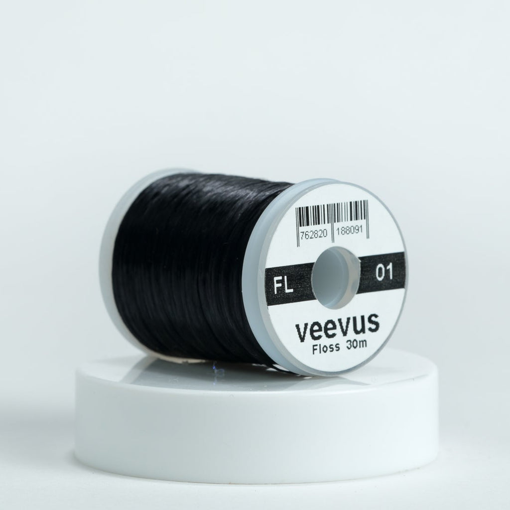 Spool of black Veevus floss on a white background