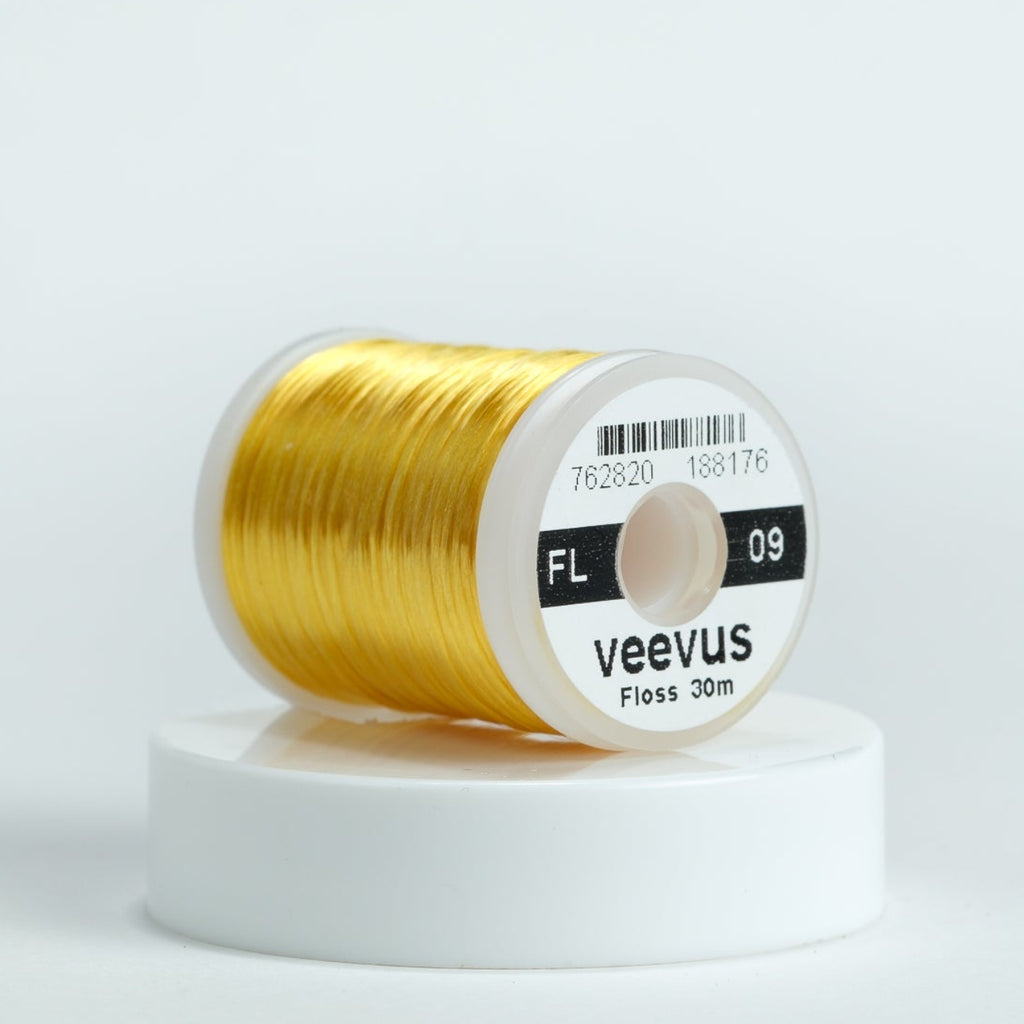 Spool of gold thread with 'veevus' branding on a white background