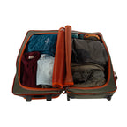 Open Green Fishpond Stormshadow Medium Rolling Duffel with orange straps on a white background with clothes and a rolled-up item on a white background