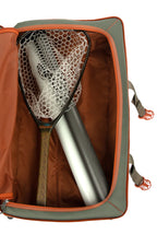Fishing net and rod in an open Green Fishpond Stormshadow Medium Rolling Duffel with orange straps on a white background orange and gray backpack on a white background