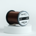 Spool of brown Veevus Thread Polyester 8/0 with 'veevus' branding on a white background