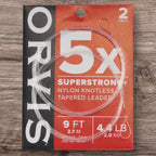 Orvis Superstrong+ fishing leader packaging on a wooden surface