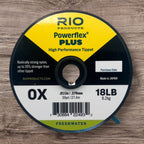Spool of Rio Powerflex Plus fishing line on a wooden surface
