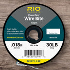 Spool of Rio Products Powerflex Wire Bite Tippet on a wooden surface