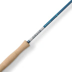Fishing rod with beige handle and blue and white label on a white background