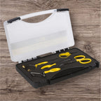 A set of fly tying tools including scissors, bobbin, bodkin, whip finisher, and hackle plier, neatly arranged in a clear top black bottom carrying case with compartments for each tool.