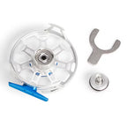 Clear mechanical component with blue tool and silver wrench on a white background