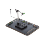 Fly tying station with a mat, vise, and accessories on a white background