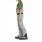 Person wearing gray pants with black accents on a white background
