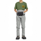 Person wearing a green shirt and gray pants with a belt on a white background