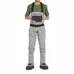 Person wearing gray waders and a green shirt on a white background