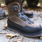 Brown and black Simms Men's G3 Guide BOA Boot - Vibram with visible brand logo on a gravel surface