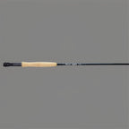 A fly fishing rod with a black carbon shaft, a light tan cork grip, and a black reel seat, shown horizontally against a solid gray background.