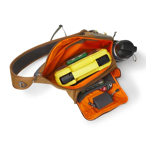An open brown and orange waist bag with a yellow flashlight, green tool, pen, and other small accessories inside, shown on a white background.