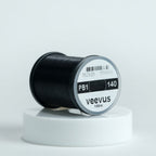 Black spool of fly-tying thread with 'veevus' branding on a white background