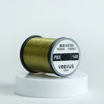 Olive spool of fly-tying thread with 'veevus' branding on a white background