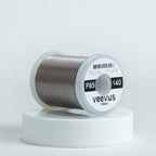 Gray spool of fly-tying thread with 'veevus' branding on a white background