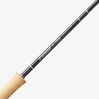 A close-up image of a Sage Salt R8 fishing rod, showing the rod's tip with a light-colored handle and black graphite body.