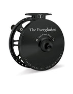 A collection of Tibor fly fishing reels in different colors displayed horizontally. The reels are labeled with their model names.