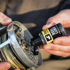 Person applying Loon Reel Lube to a fly fishing reel