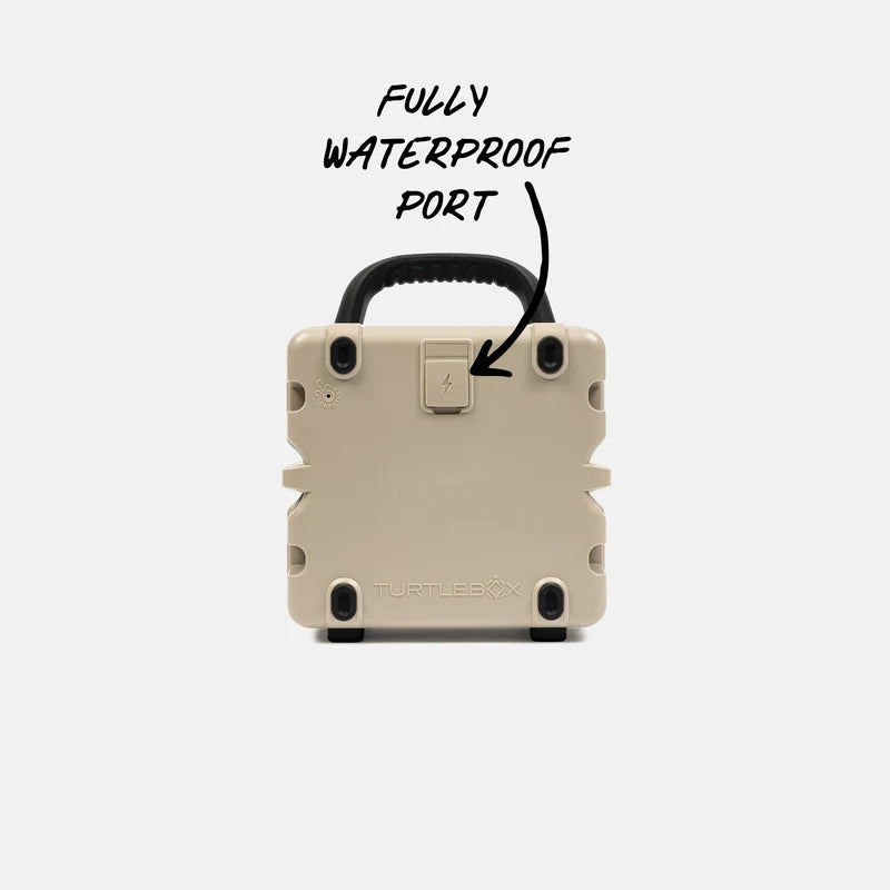 Tan Turtlebox Cub speaker with the handle and 'FULLY WATERPROOF PORT' text on a white background