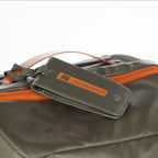 Gray bag with orange accents and a matching tag on a white background