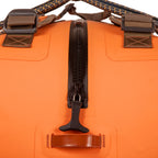 Close-up of a Fishpond submersible orange duffel bag with a black zipper and brown straps on a white background