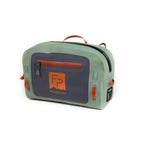 A green Fishpond Thunderhead Small Submersible Lumbar pack and zippered closures, featuring a logo on the front.