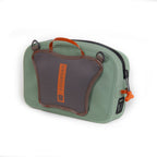 A green Fishpond Thunderhead Small Submersible Lumbar pack with a brown shoulder strap and zippered closures, featuring a logo on the front and a net holster on the back.