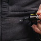 Person using a black marker to write on a dark fabric surface