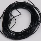 Coiled black Hareline Vinyl Rib on a white background