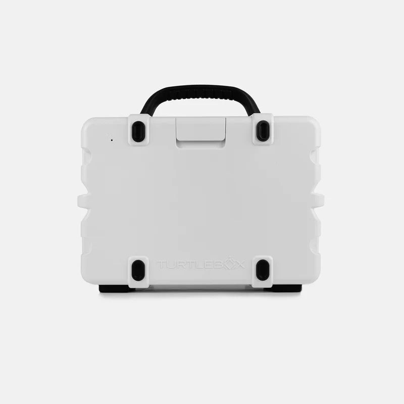White hard-shell Turtlebox Original Gen 3 speaker with black handle on a light gray background