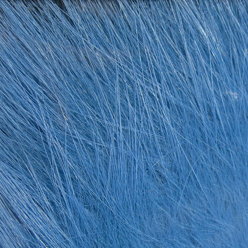 A close-up of a bundle of blue, Hareline Arctic Fox Hair for fly tying, commonly used in crafting fishing flies.