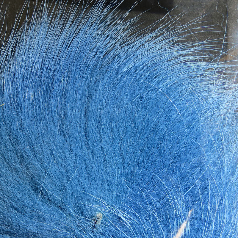 Colorful fox tail hair on a wooden surface