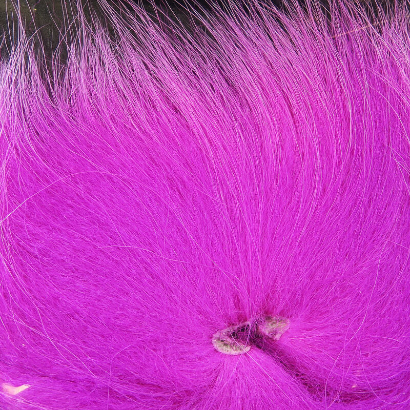 Colorful fox tail hair on a wooden surface