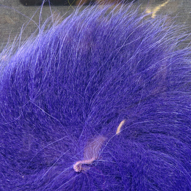 Colorful fox tail hair on a wooden surface